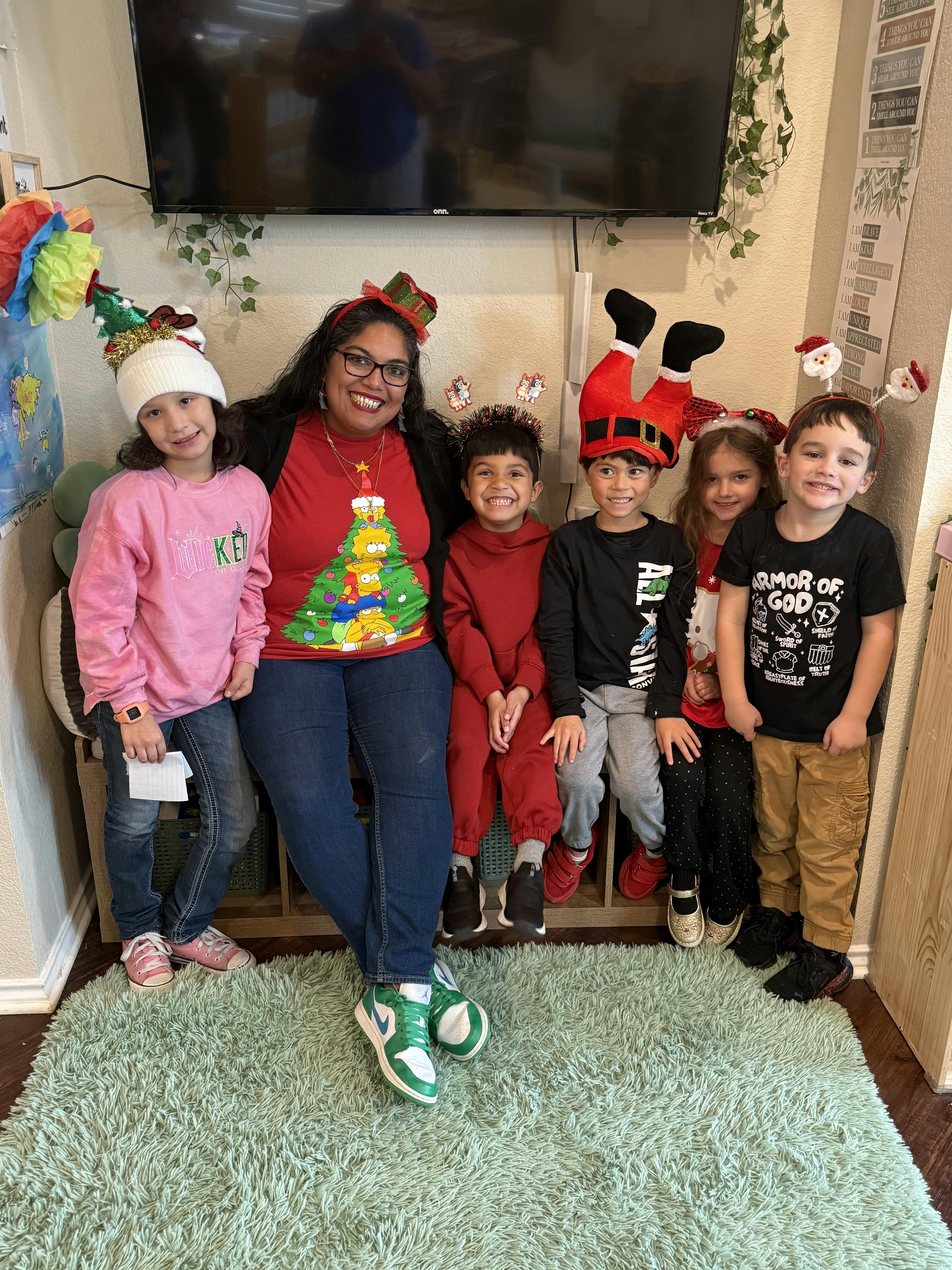 A person and five children wearing festive Christmas attire