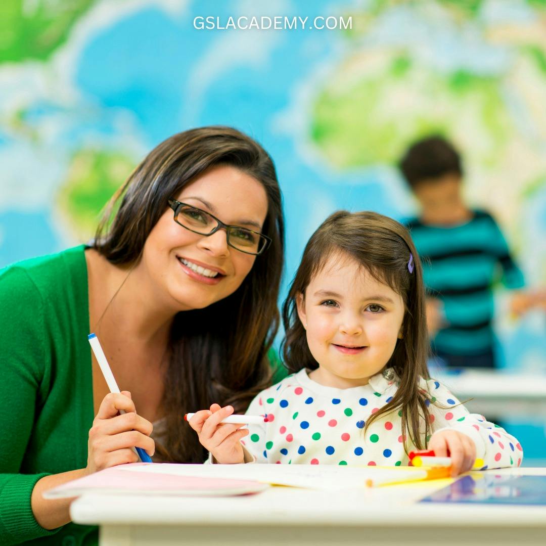 Person and child holding markers at a desk