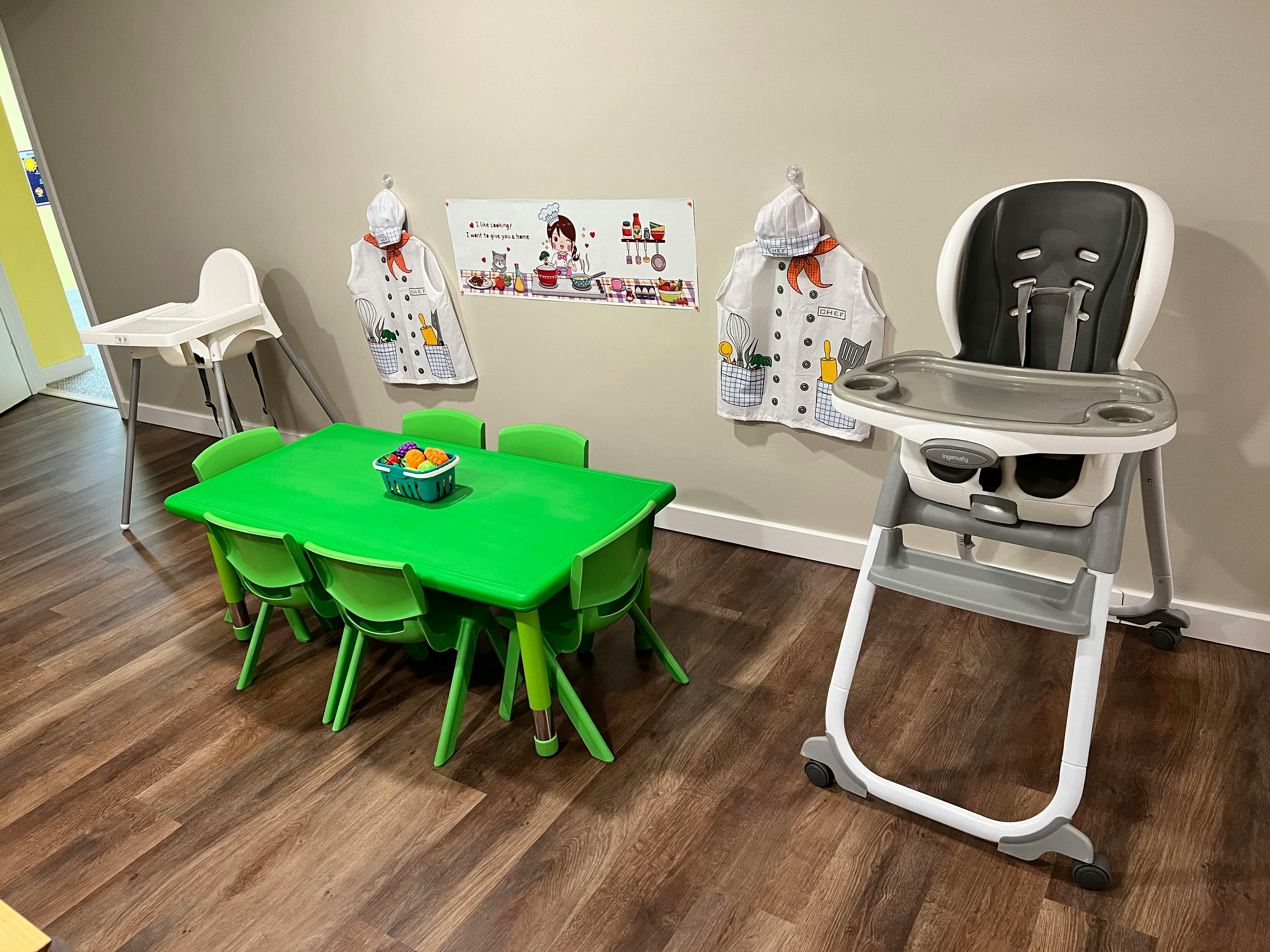 Green children's table with chairs and two high chairs