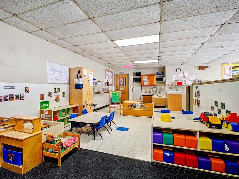 Classroom with child-sized furniture and colorful toy storage
