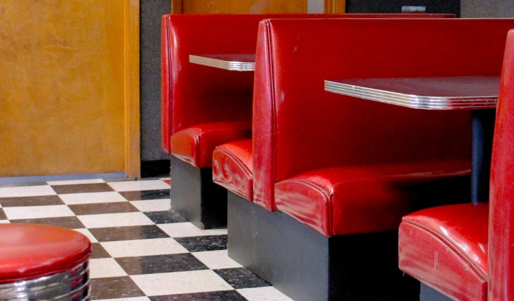 Red diner booths and a black and white checkered floor