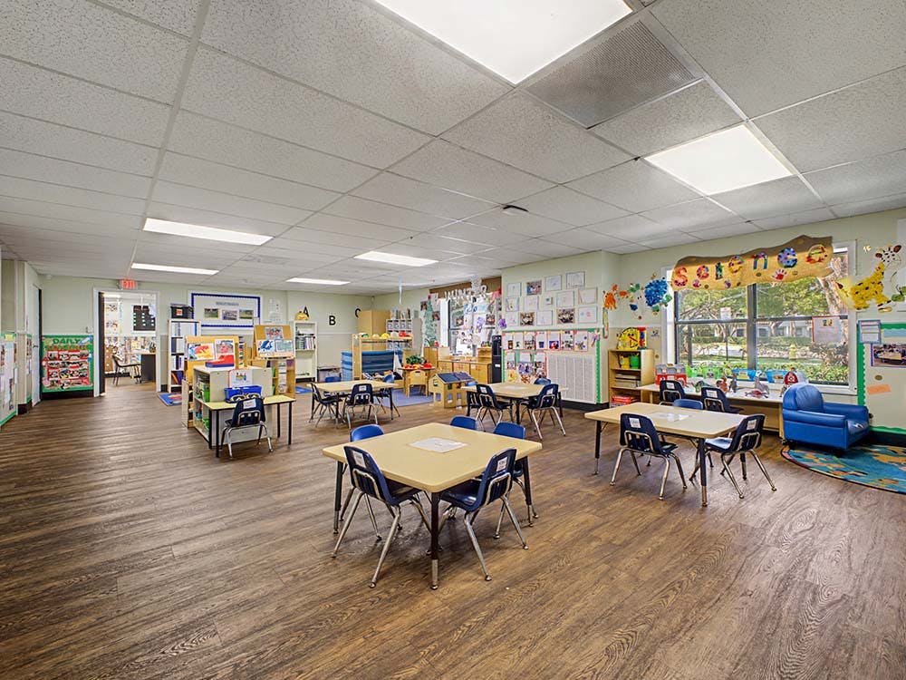Empty classroom with small tables and chairs