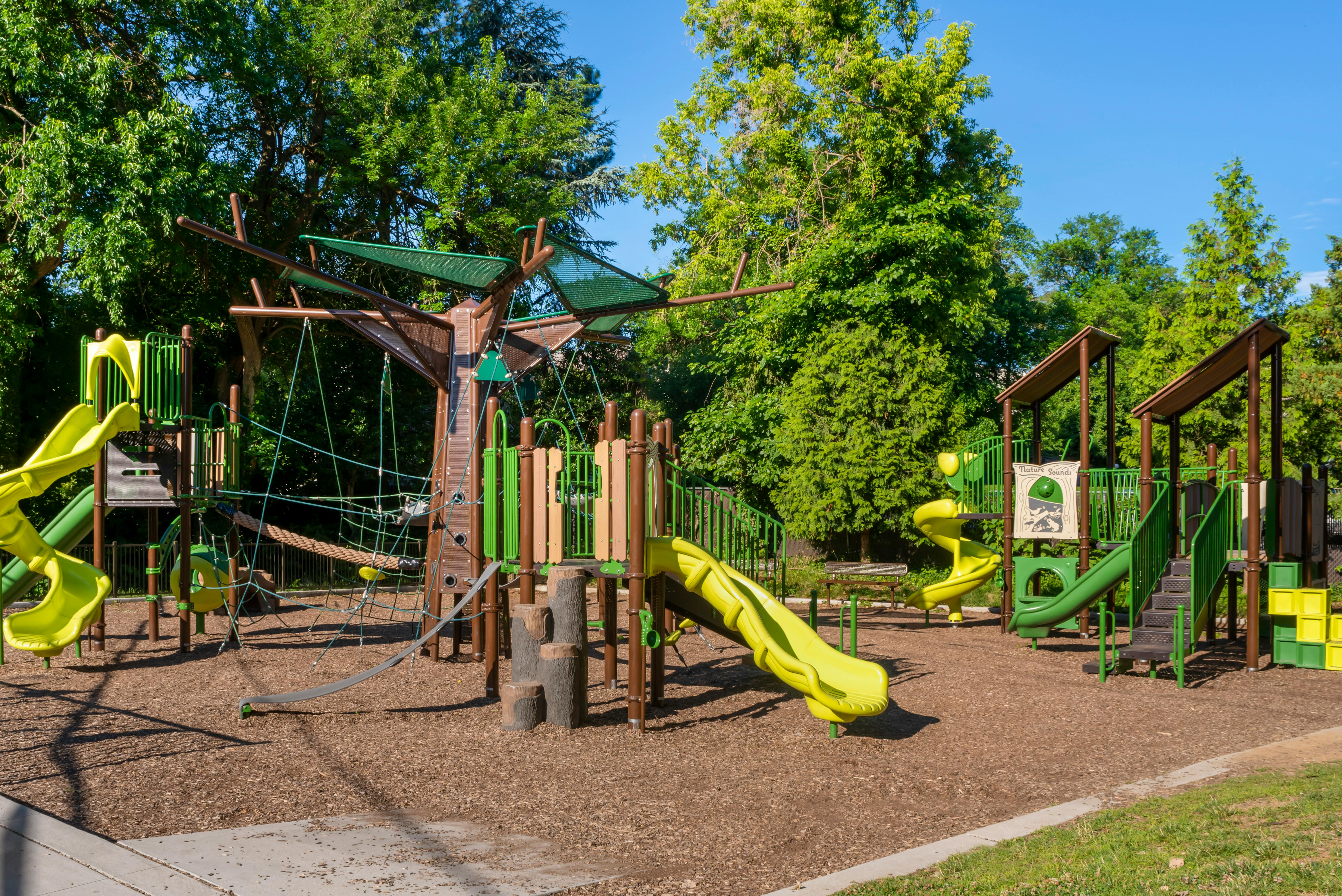 Empty children's playground with multiple slides and climbing structures