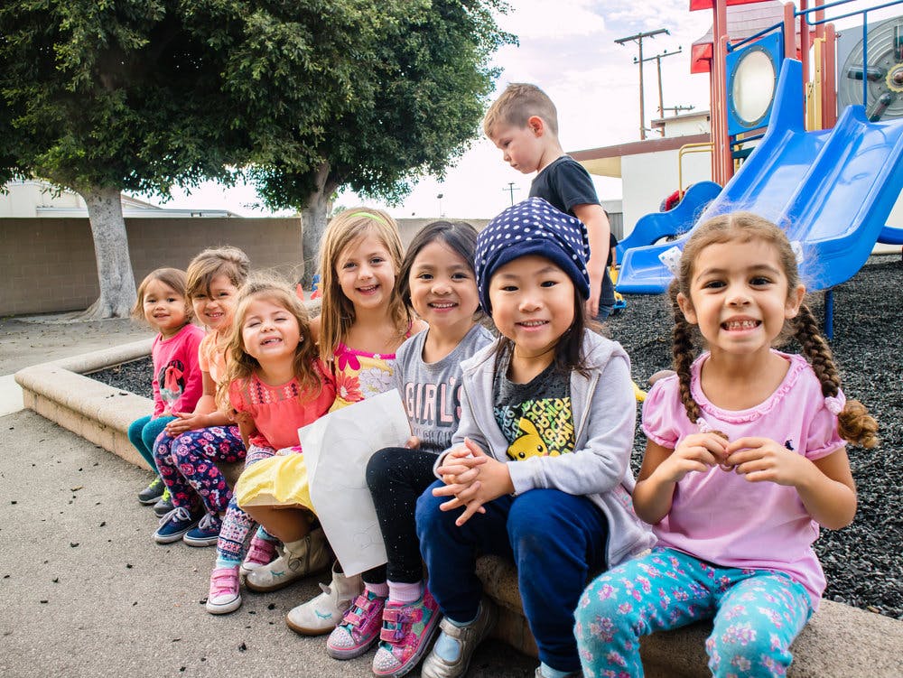 Group of children sitting together outdoors