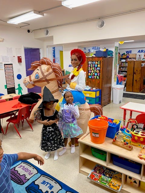 Person in horse costume with two children in costumes