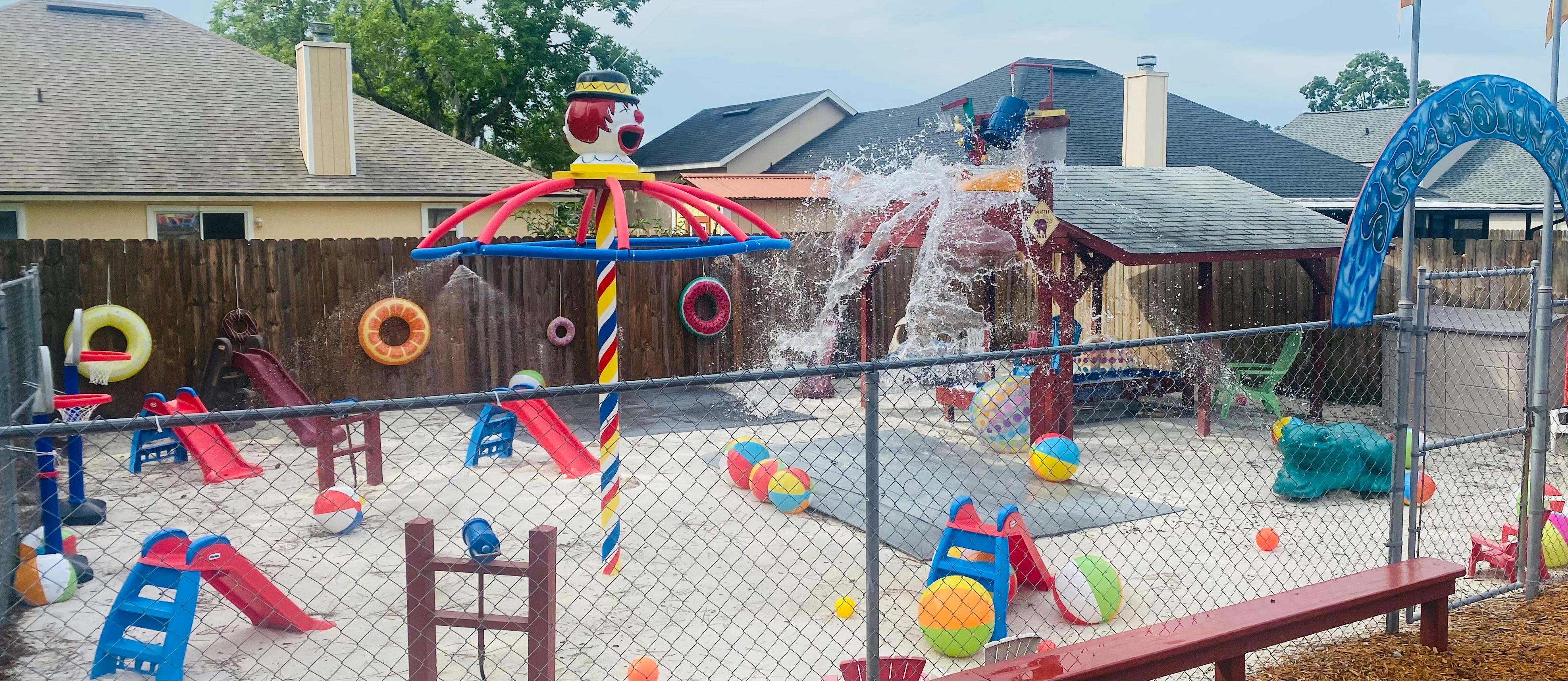 Outdoor playground with water features, slides, and sand