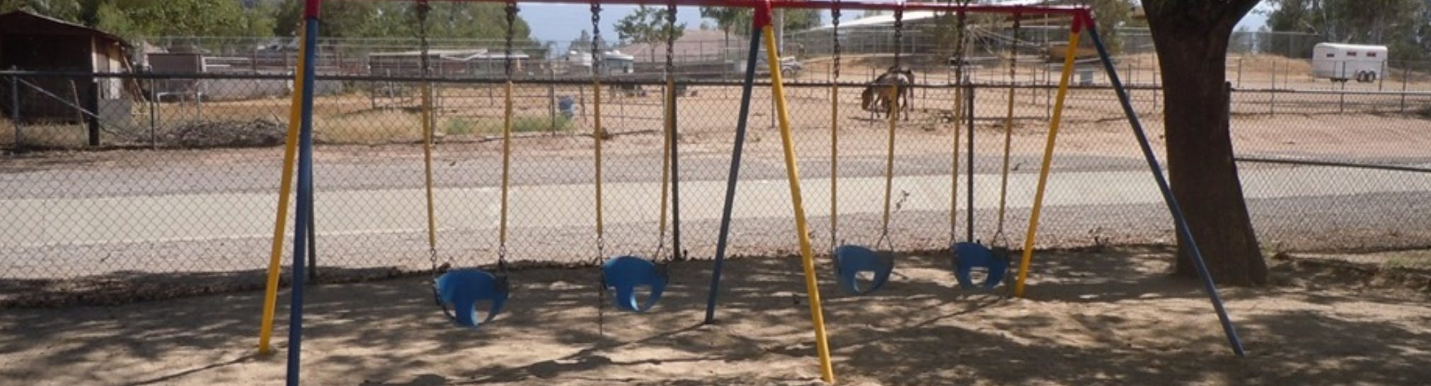 Empty swing set with four swings