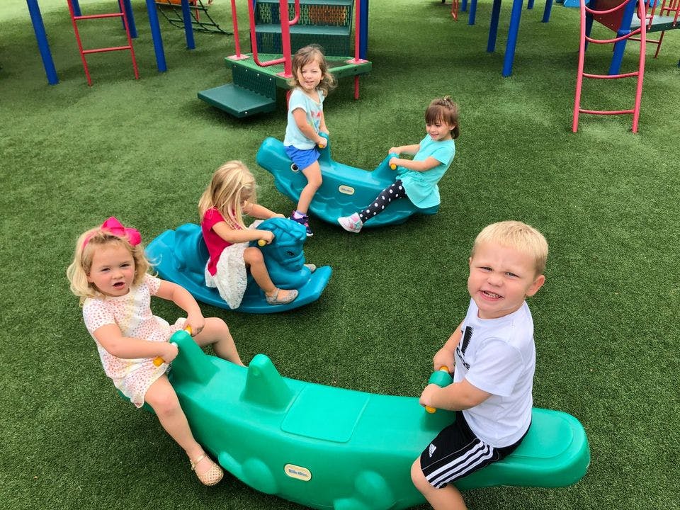 Children playing on spring riders on a playground