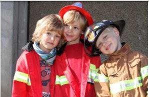 Three children in firefighter costumes