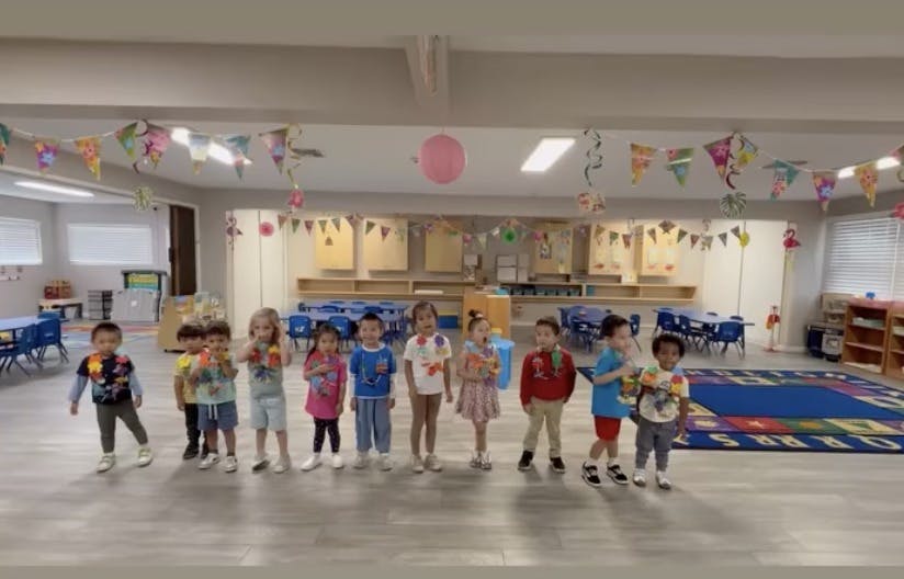 Group of children standing in a classroom