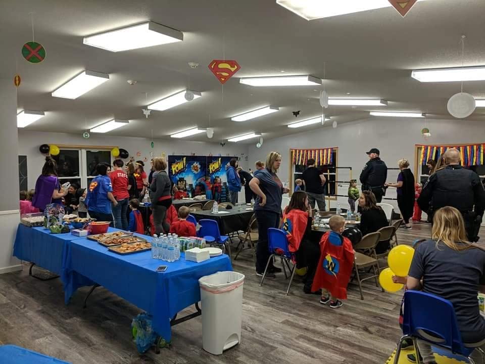 People gathered in a room with tables and decorations
