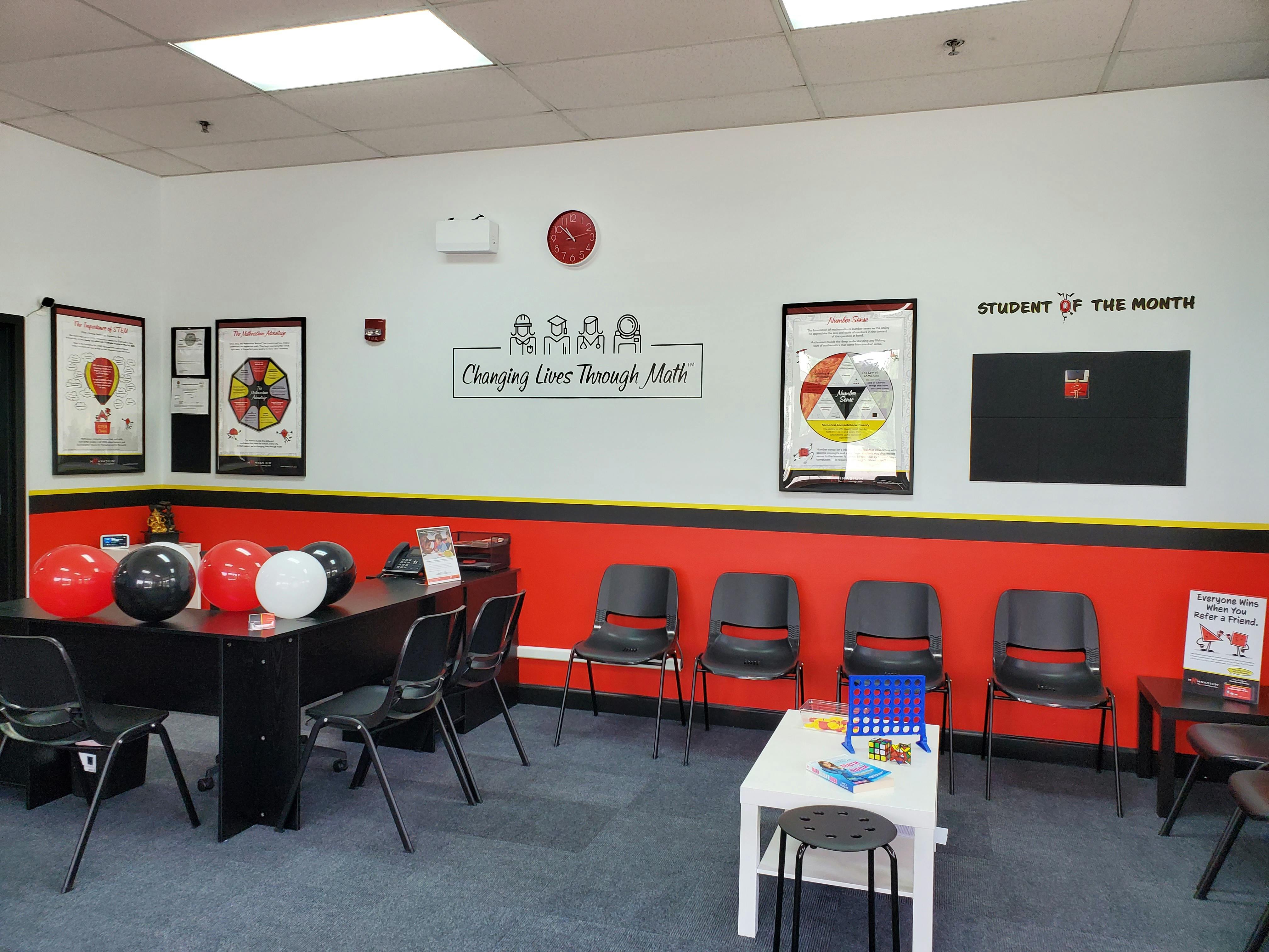 Reception area or classroom waiting area with red and black decor