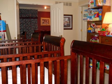 Multiple wooden cribs in a room