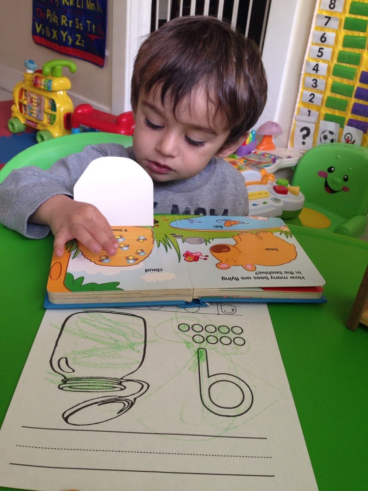 Child looking at a book with a pop-up element