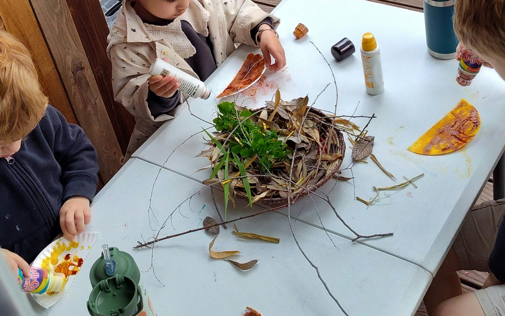 Children doing an art activity with natural materials