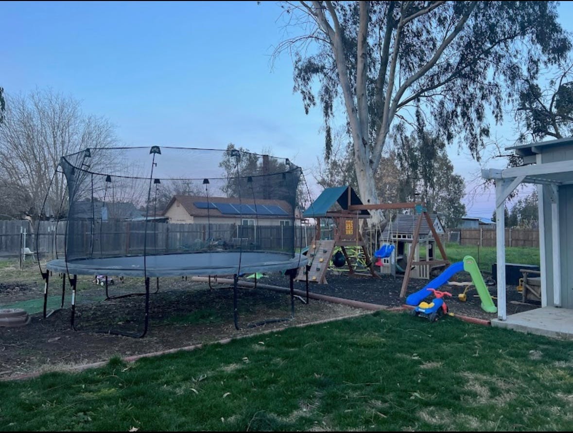 Trampoline and playground in a backyard