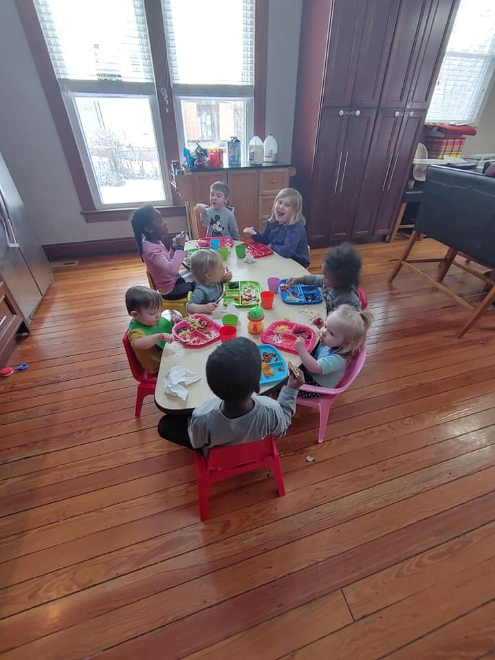 Children sitting around a table with plates and cups