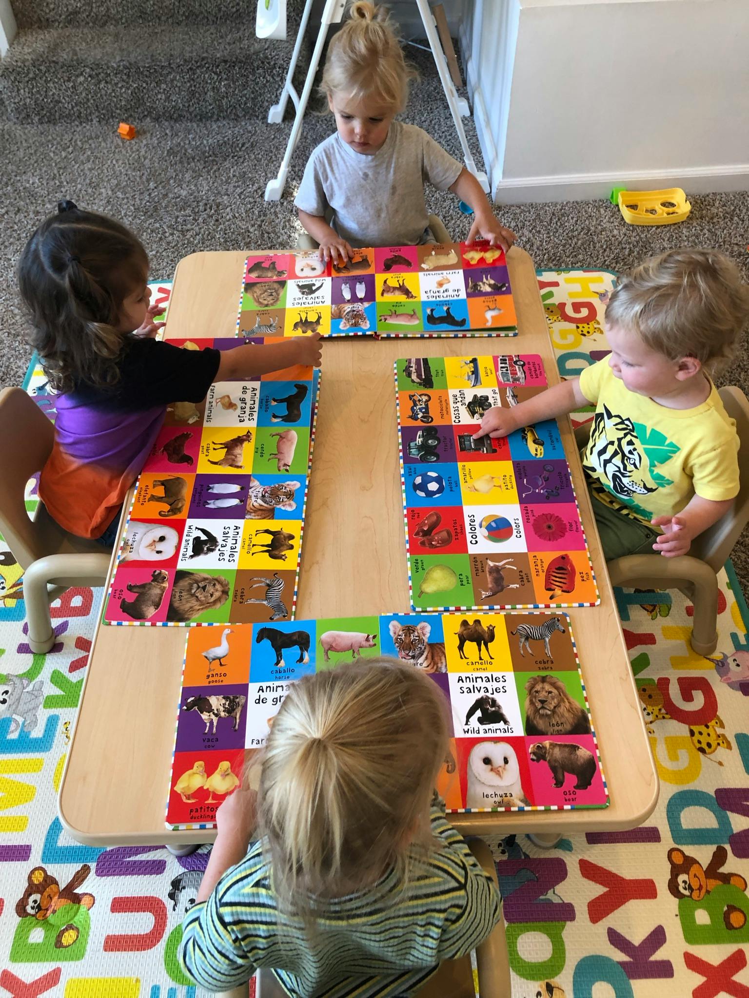 Children playing with animal picture cards at a table