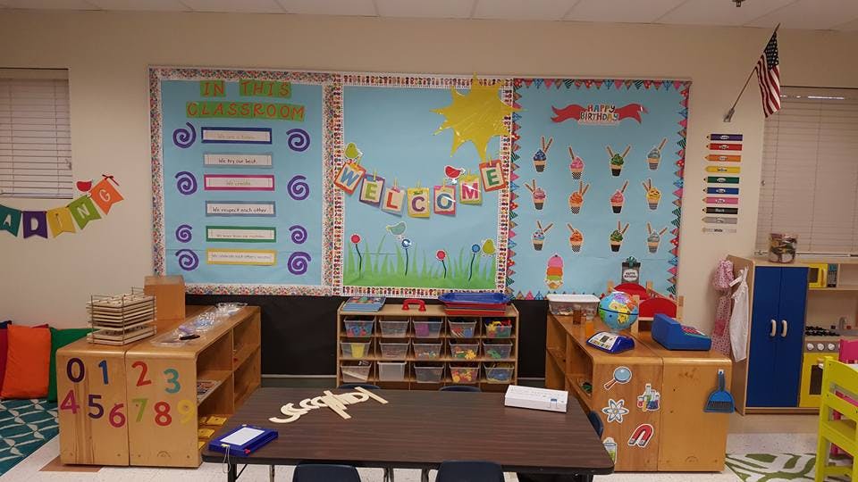 Classroom with bulletin boards, tables, and storage shelves