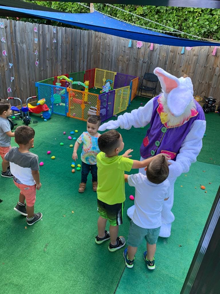 Children interacting with a person in a bunny costume outdoors
