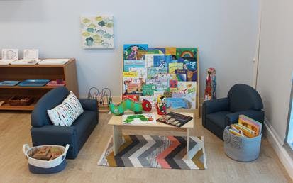 Children's reading nook with small furniture and books