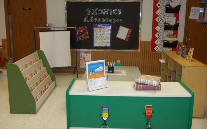 Classroom with a Phonics Adventures display board and a small table with books