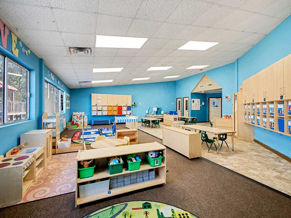 Classroom with child-sized furniture and bright blue walls