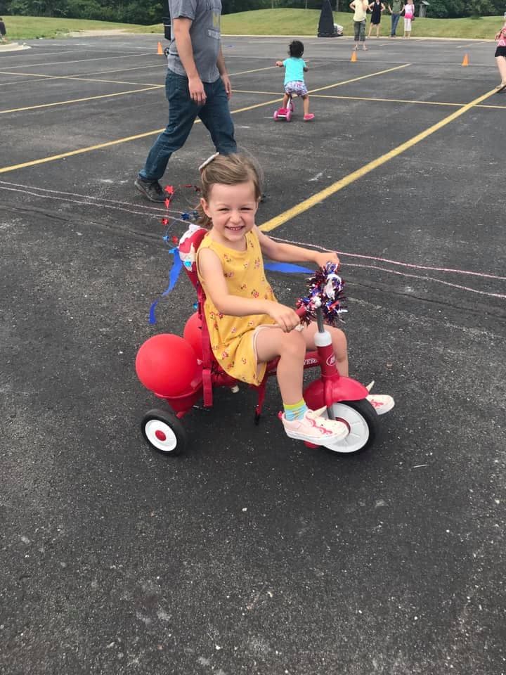 Child on a red tricycle