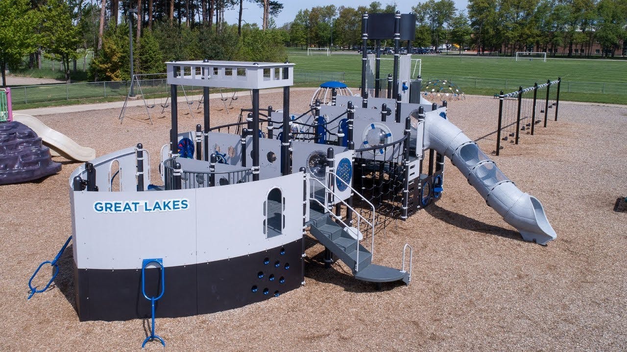 Playground structure shaped like a ship with "GREAT LAKES" on its side