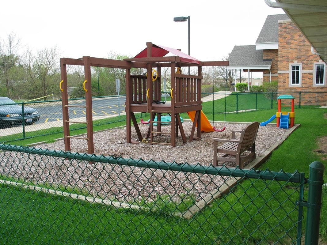 Playground with swings, slide, and play structure