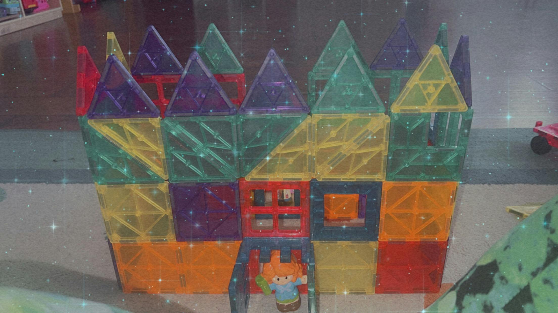 Colorful magnetic tile castle with a toy figure in front