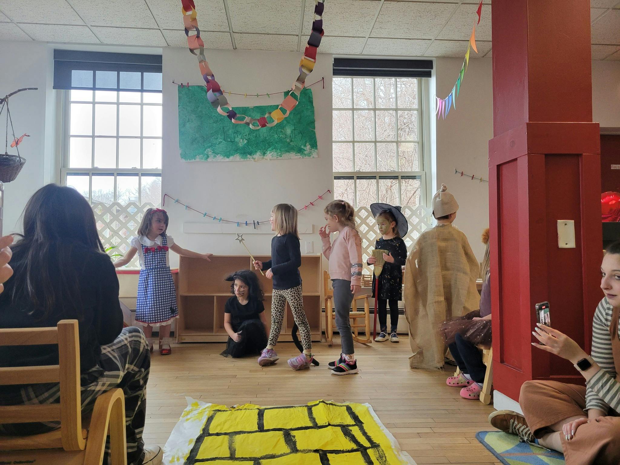 Children in costumes performing in a room