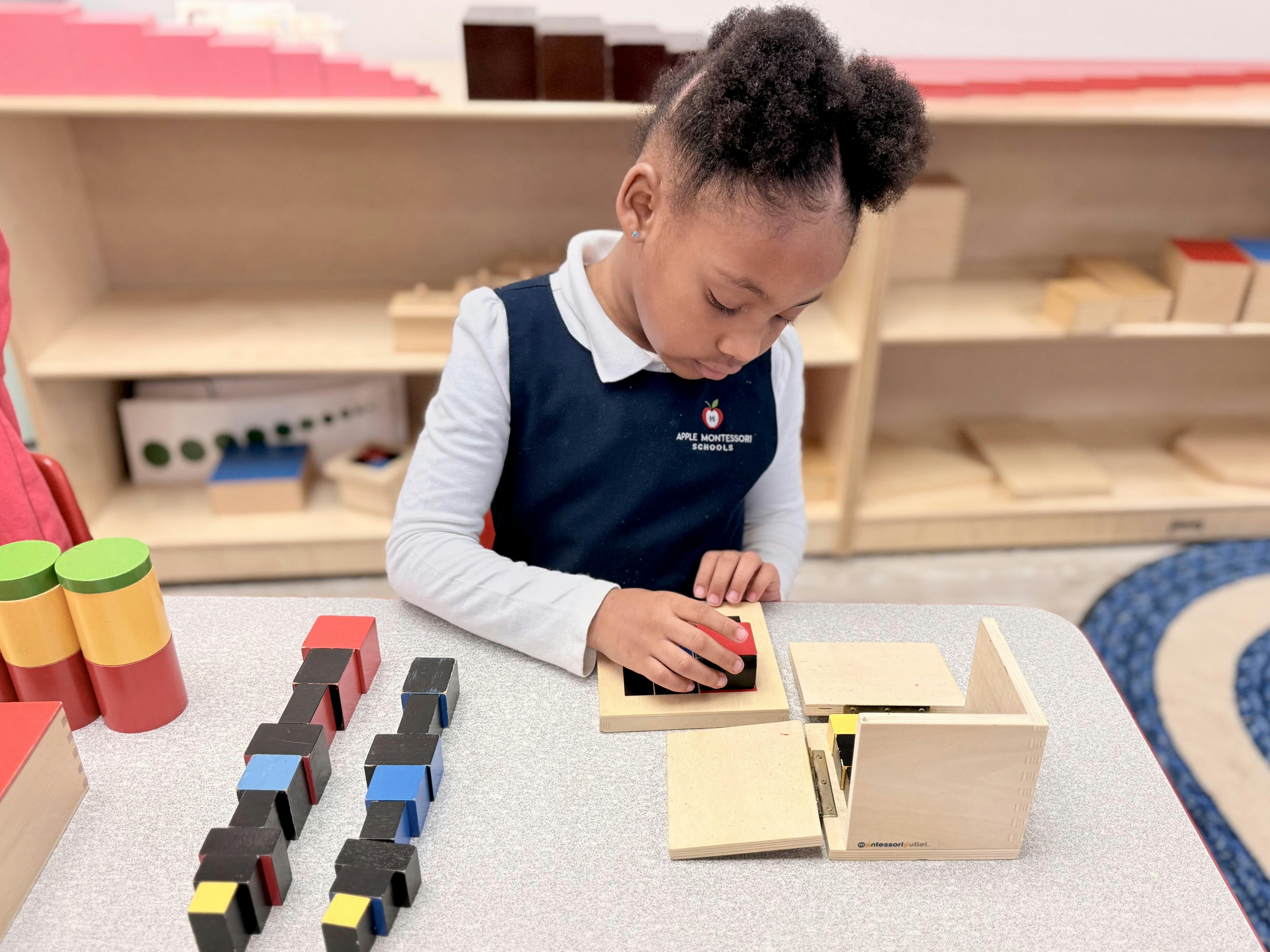 Child manipulating building blocks and wooden puzzle in a classroom