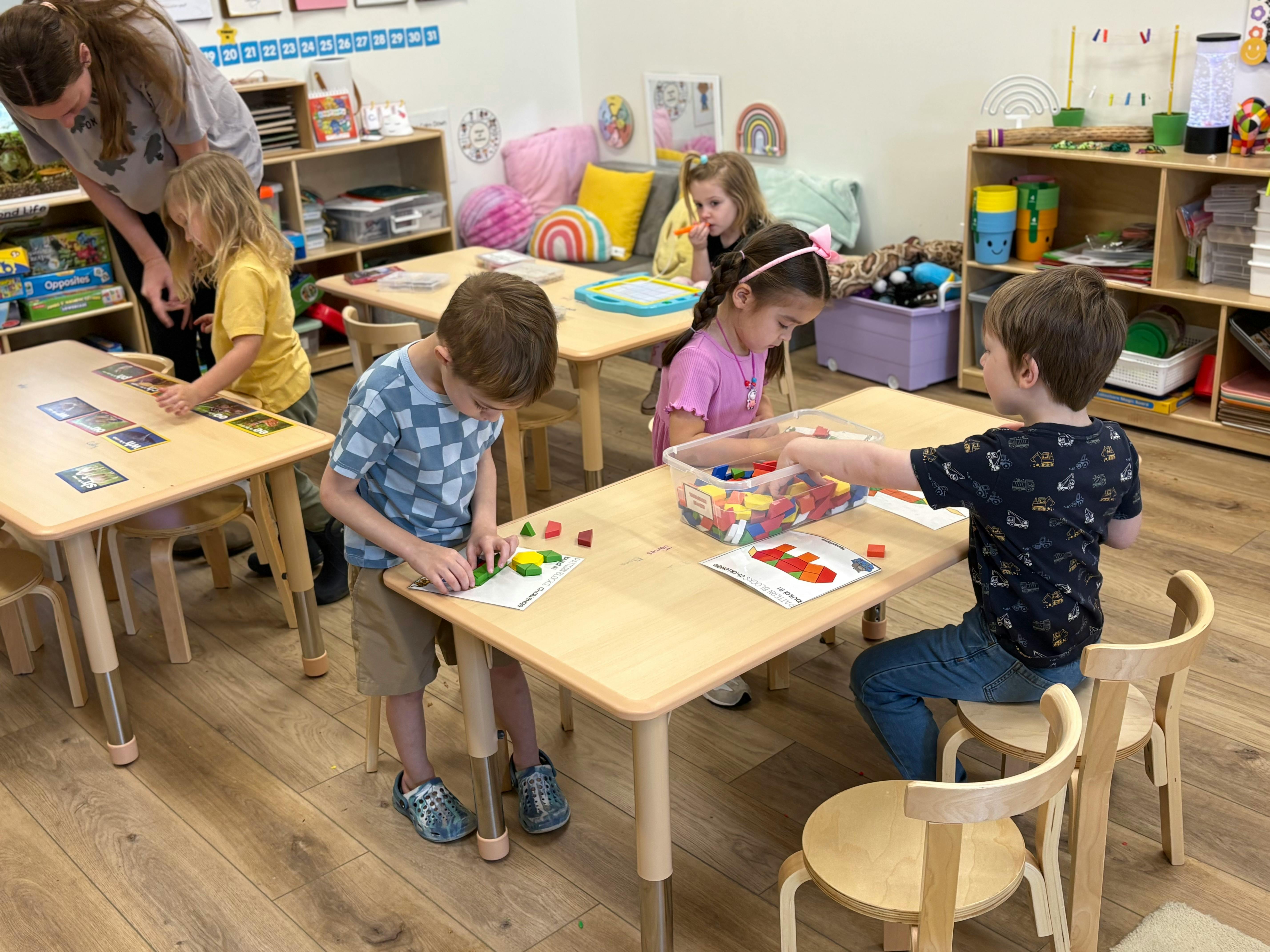 Teacher and children engaged in activities in a classroom