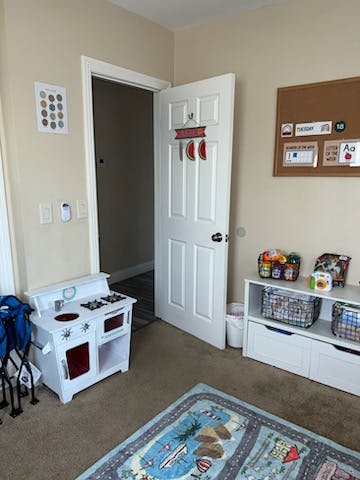 Child's play kitchen and storage unit in a room