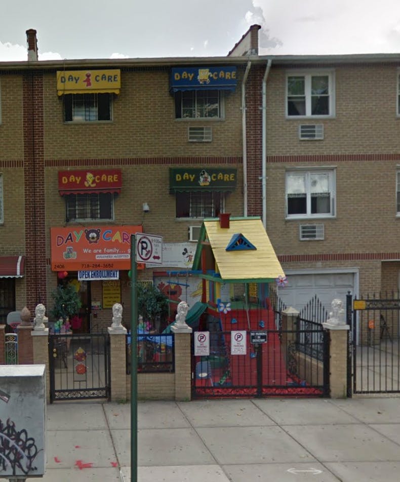 Building with "Day Care" awnings and a small playhouse in front