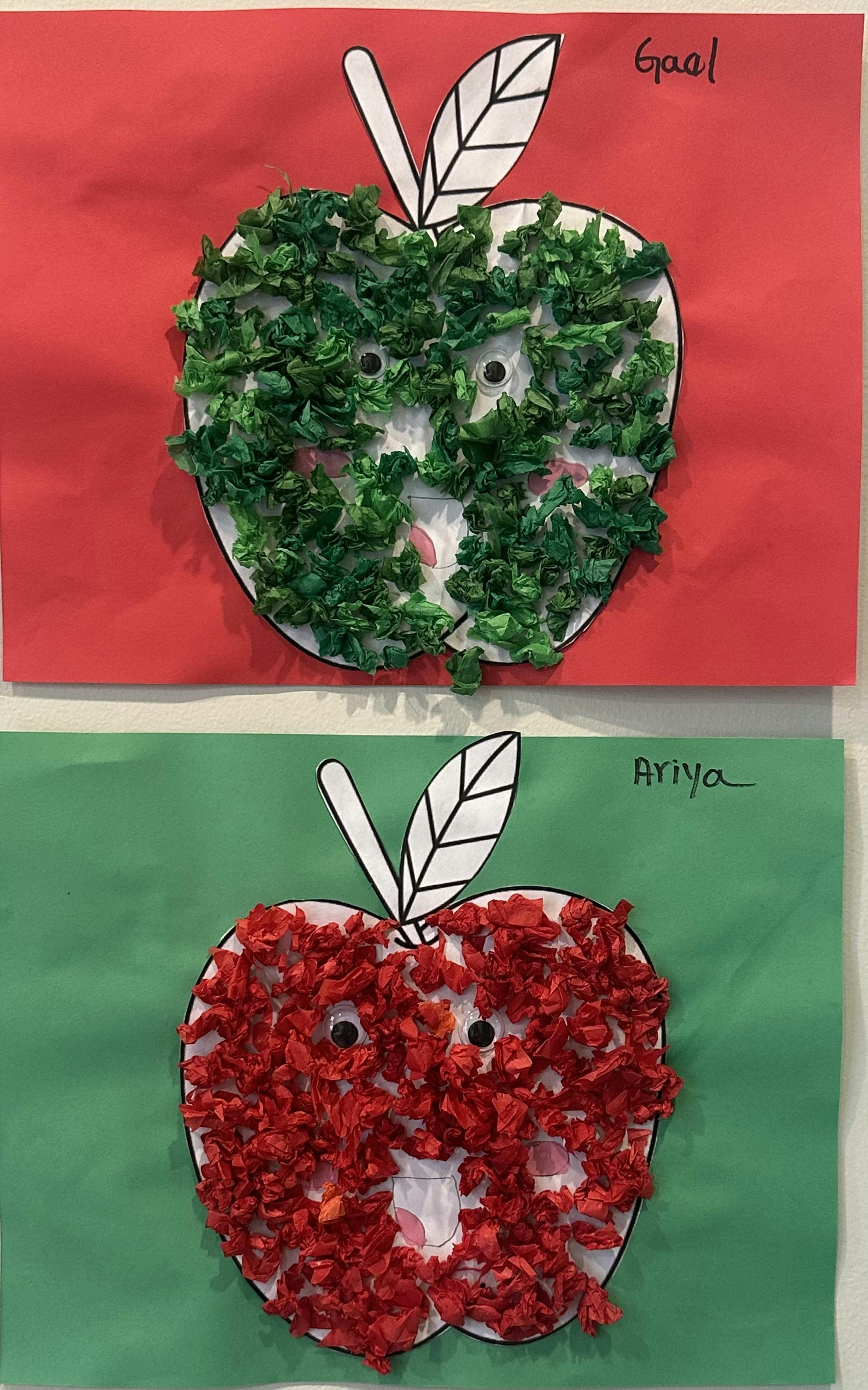 Two apple crafts made from paper and crumpled tissue paper, one green and one red