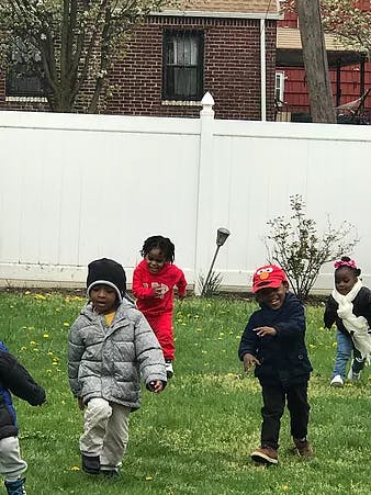 Children playing outdoors on grass