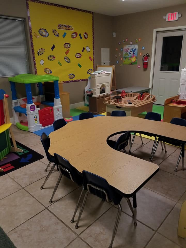 Empty classroom with a U-shaped table and chairs