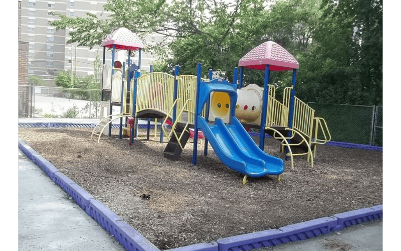 Colorful playground structure with slides on wood chips