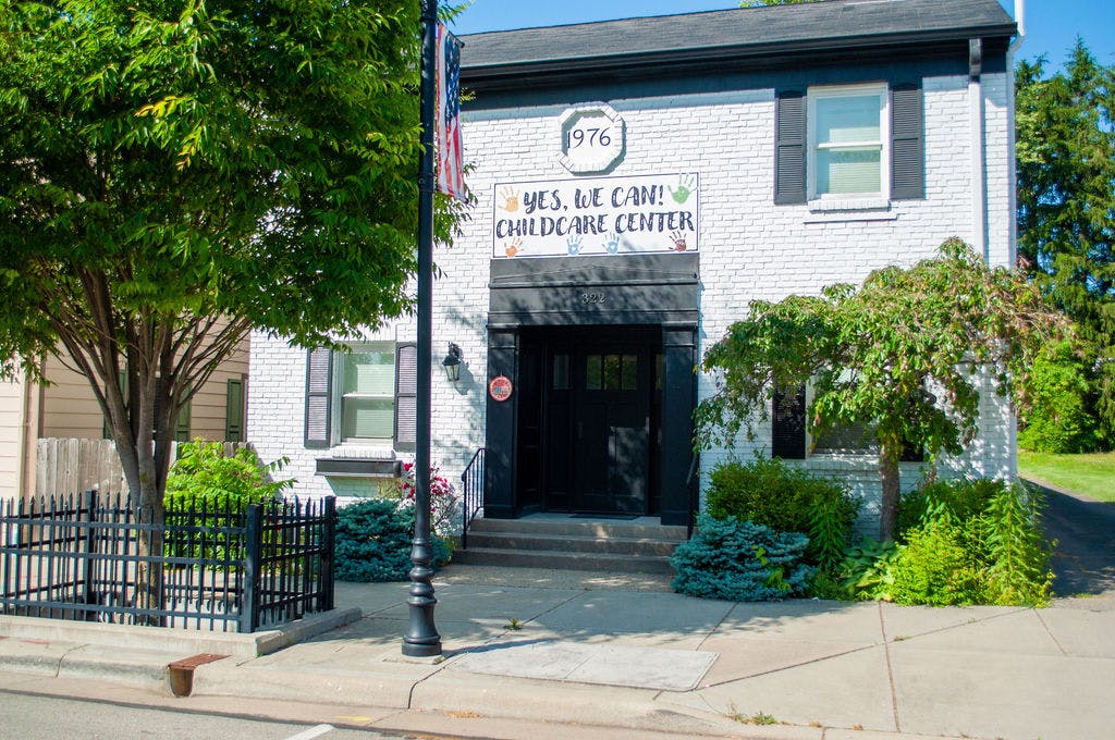 Building with "Yes, We Can! Childcare Center" sign