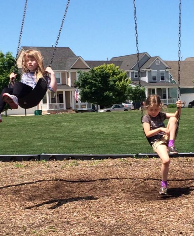 Two children on swings at a playground