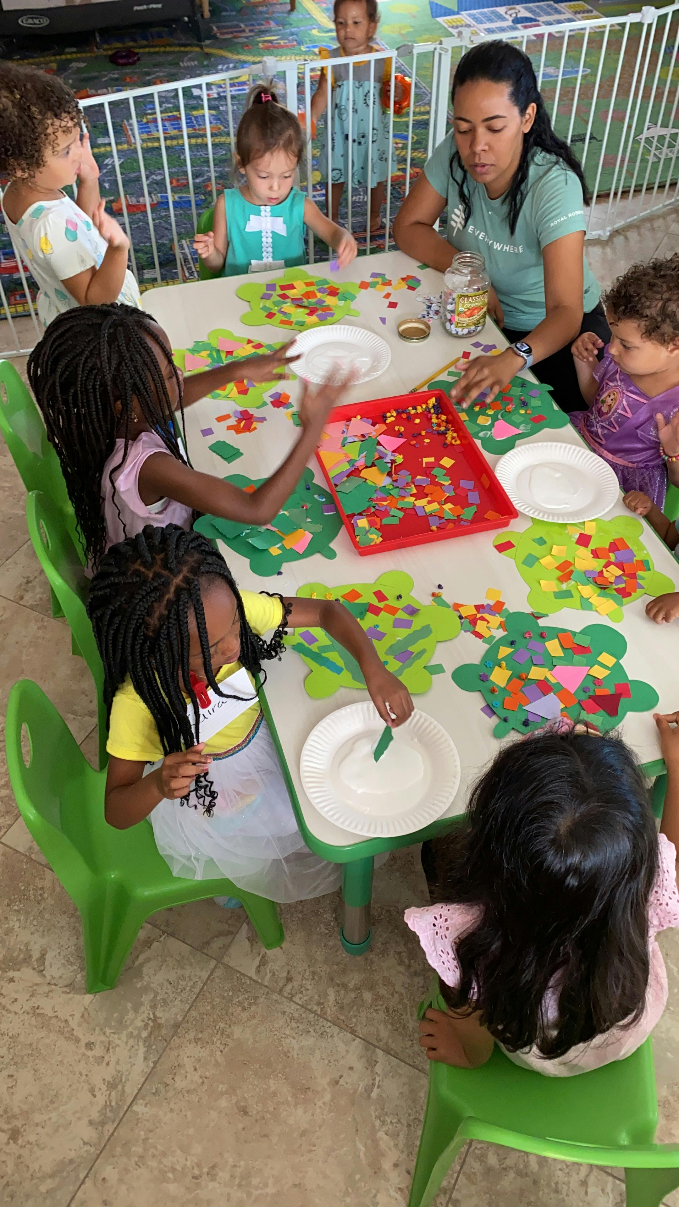 Adult and children doing crafts at a table