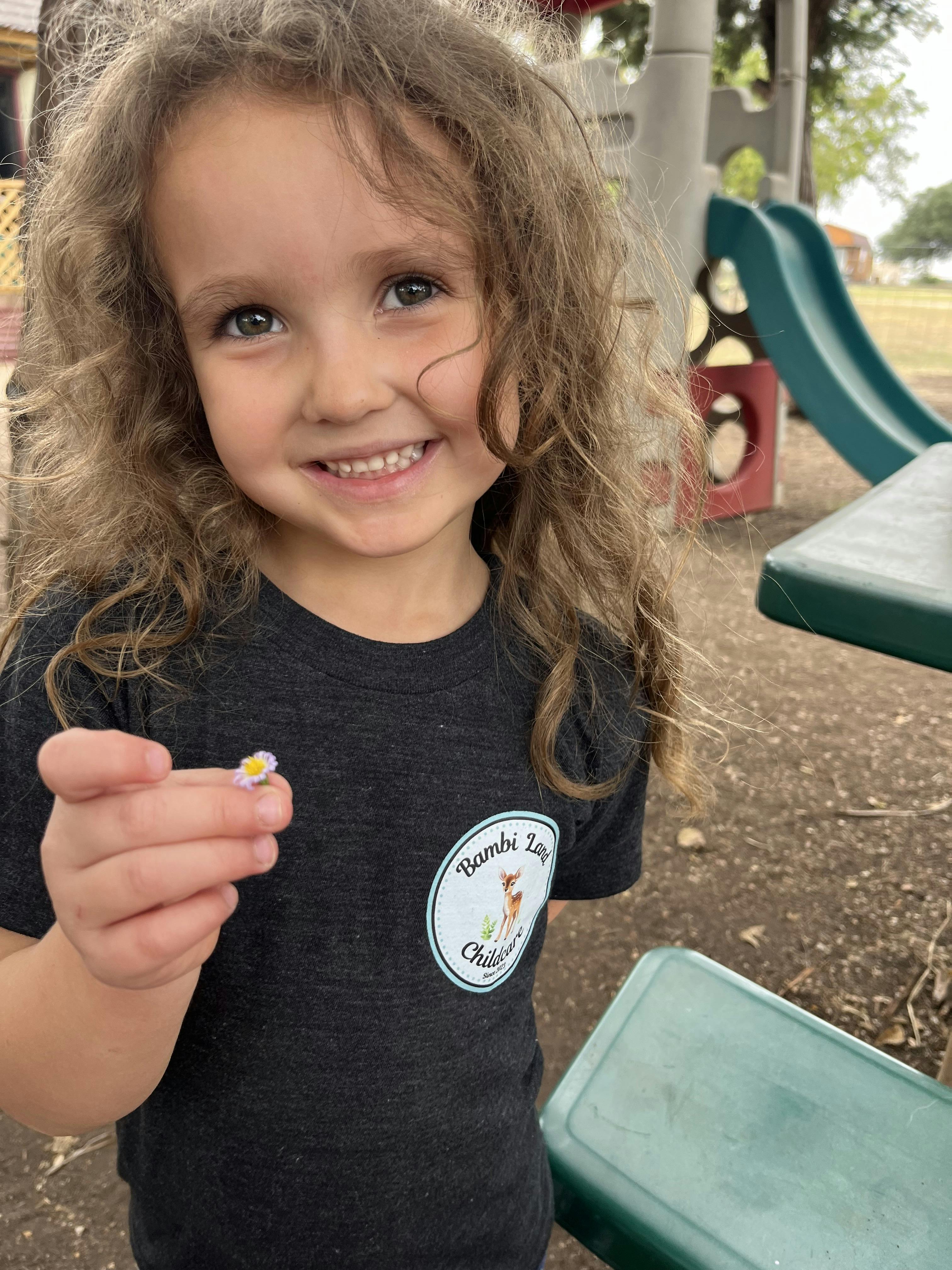 Child holding a small flower