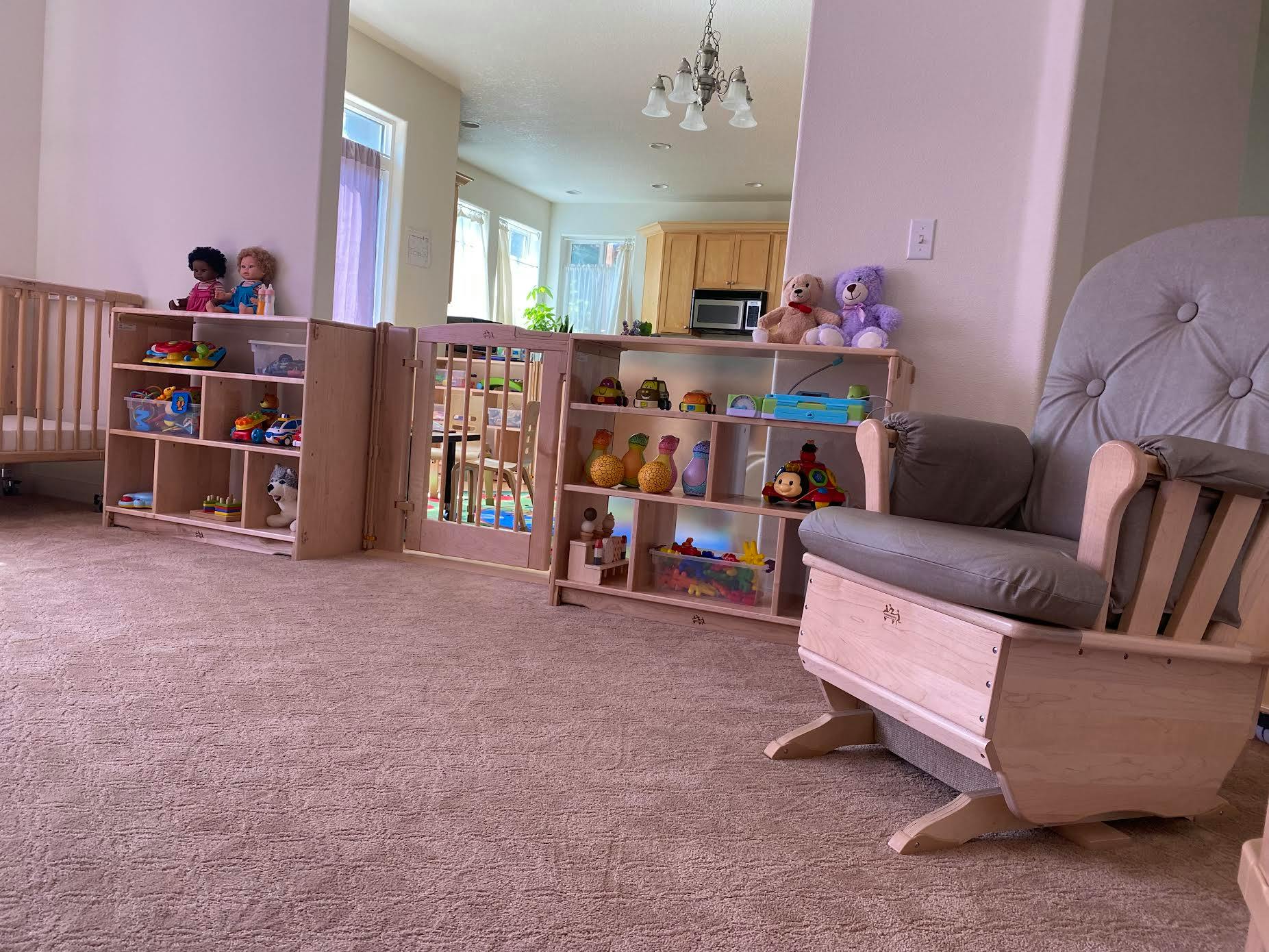 Nursery room with crib, bookshelves, and rocking chair