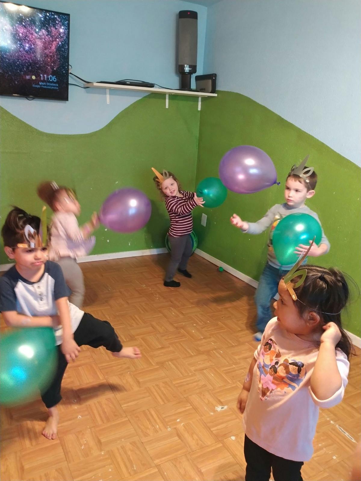 Children playing with balloons in a room