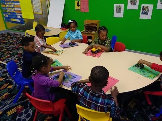 Children sitting around a table in a classroom