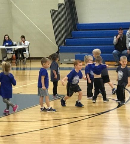 Children playing on a basketball court