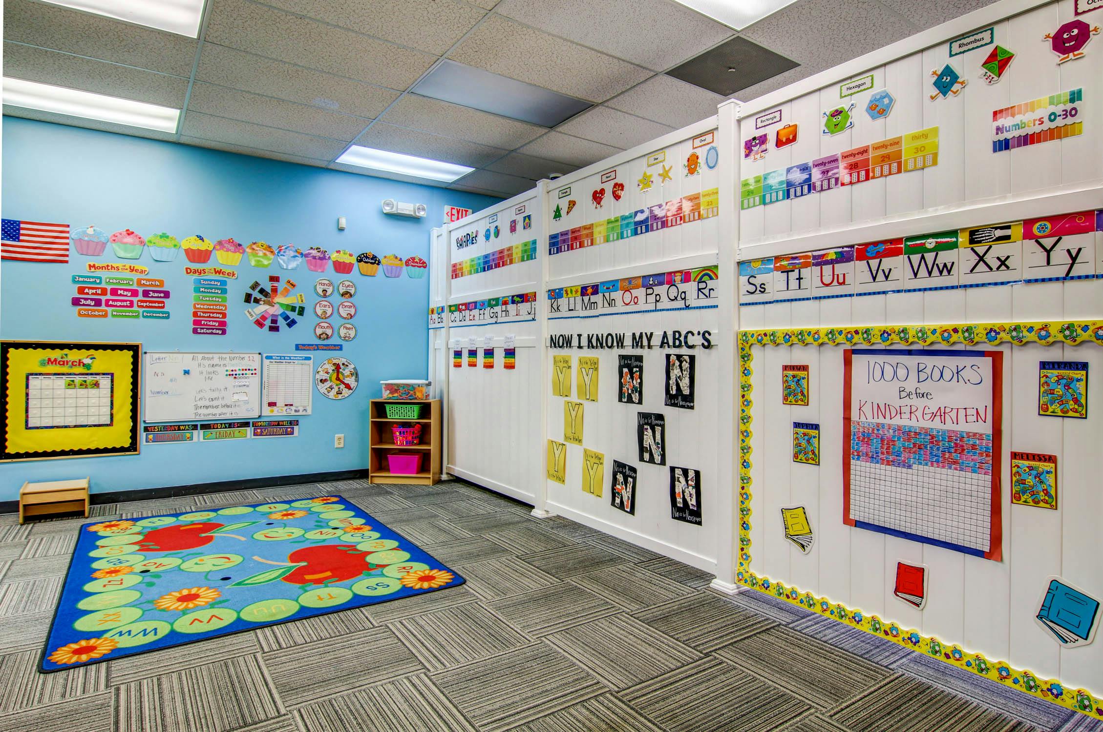 Classroom with colorful decorations and a blue rug