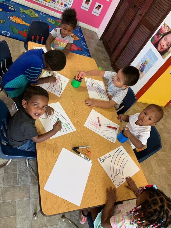 Children coloring at a table